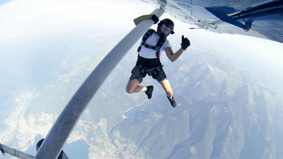 Daniel Ossio holding onto airplane before jump